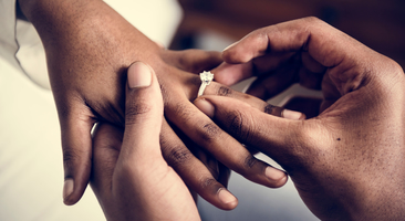 a happy couple exchanges rings at their Gulf Coast wedding